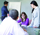 Group of people conversing in a corporate boardroom