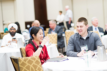 two people having a conversation in a banquet hall